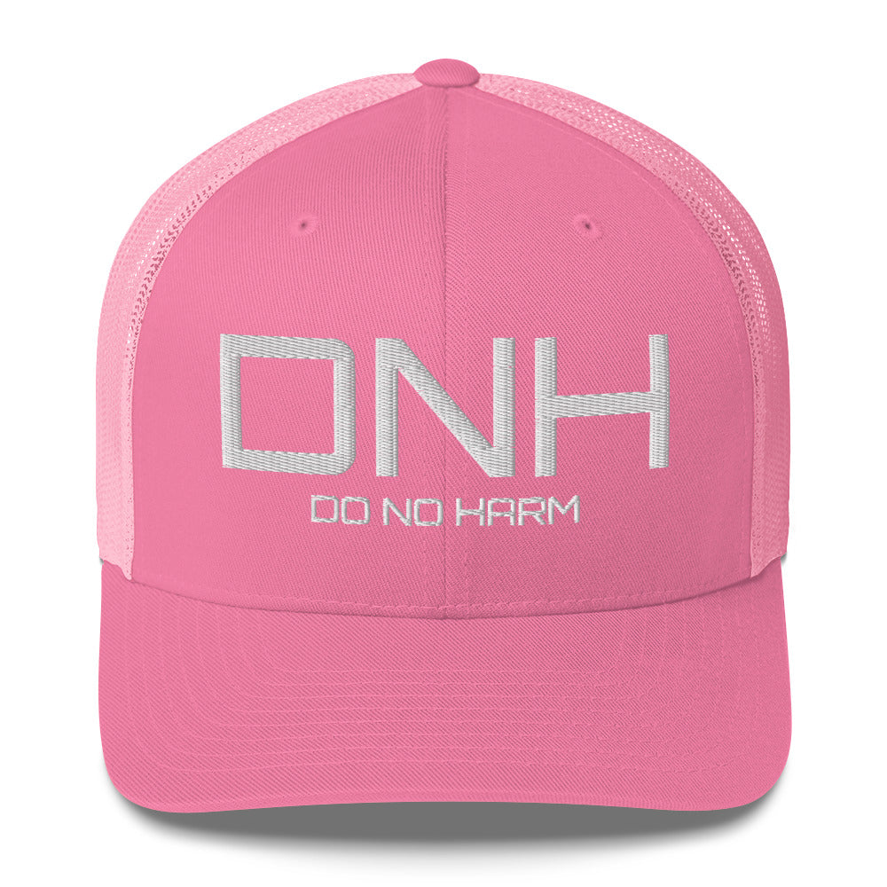 Front facing graphic trucker hat in color pink, featuring the initialism 'DNH', and the statement 'DO NO HARM,' in bold white embroidery. From What Was Said (Statement Apparel + More).