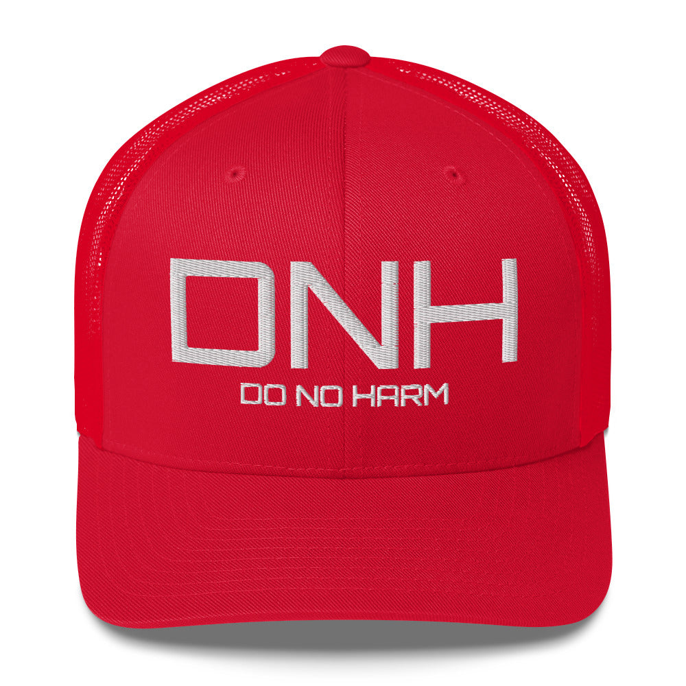 Front facing graphic trucker hat in color red, featuring the initialism 'DNH', and the statement 'DO NO HARM,' in bold white embroidery. From What Was Said (Statement Apparel + More).