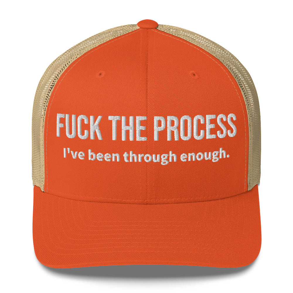 Front facing graphic trucker hat in color rustic orange and khaki, featuring the statement 'FUCK THE PROCESS, I've Been Through Enough,' in bold white embroidery. From What Was Said (Statement Apparel + More).