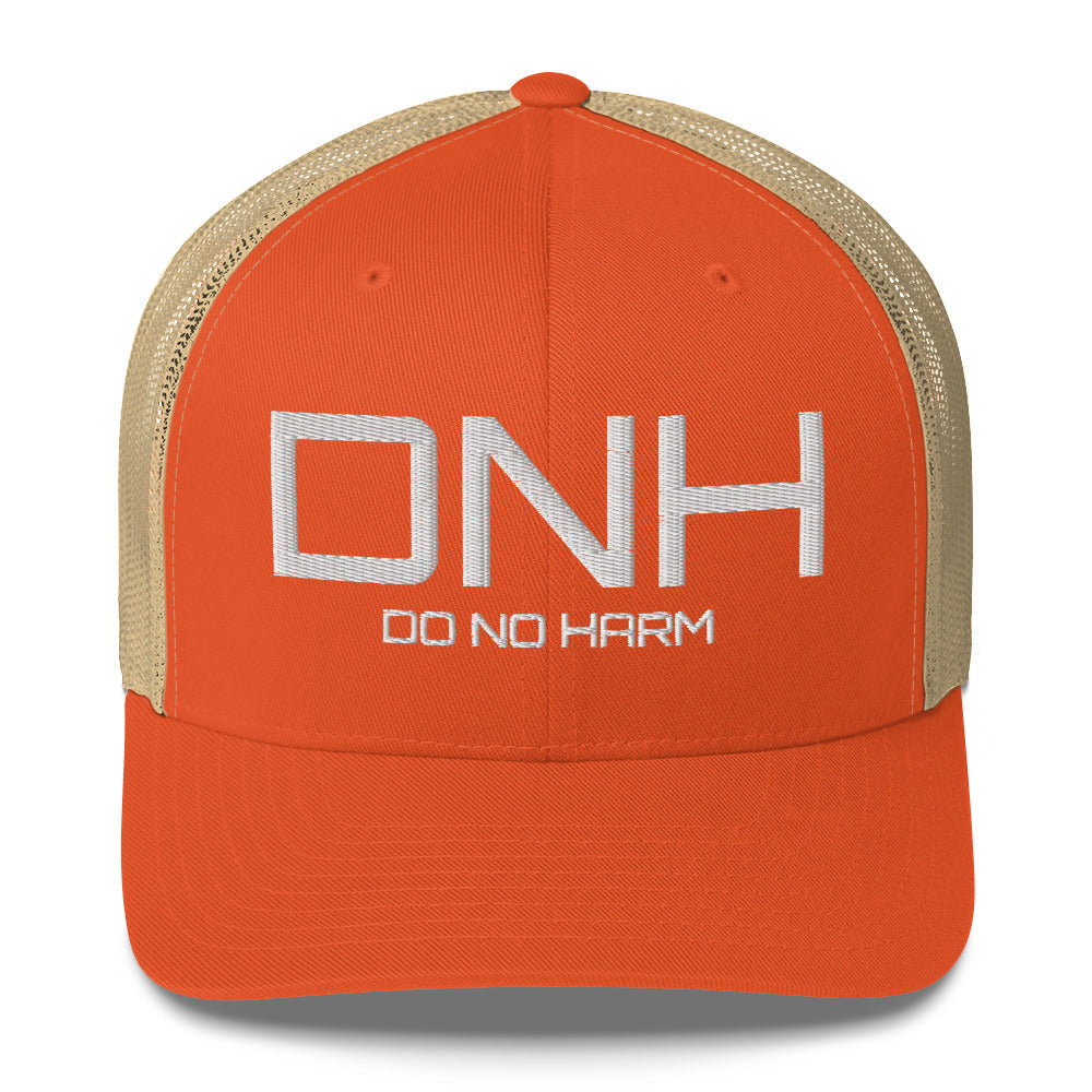 Front facing graphic trucker hat in color rustic orange and khaki, featuring the initialism 'DNH', and the statement 'DO NO HARM,' in bold white embroidery. From What Was Said (Statement Apparel + More).