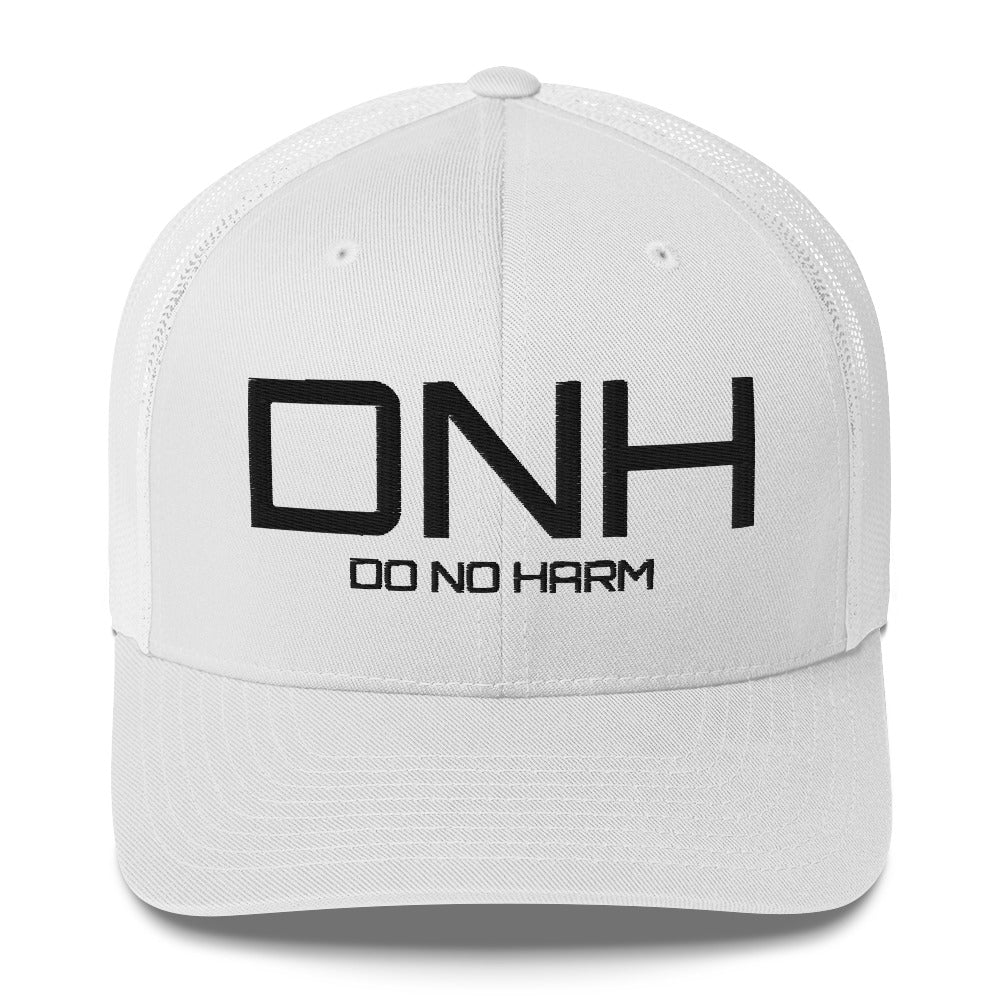Front facing graphic trucker hat in color white, featuring the initialism 'DNH', and the statement 'DO NO HARM,' in bold black embroidery. From What Was Said (Statement Apparel + More).