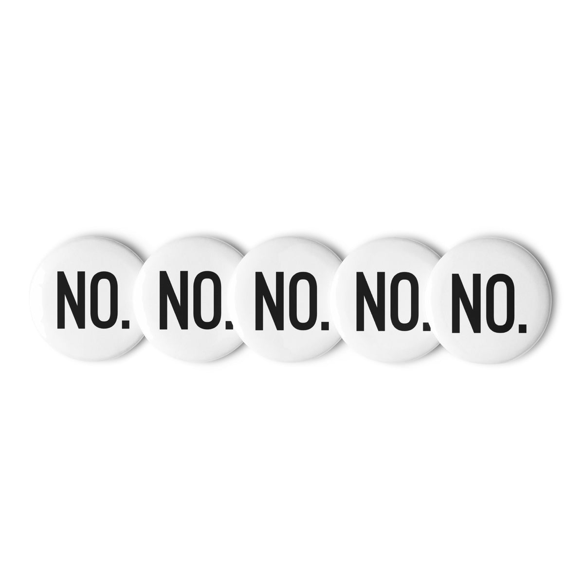 Front facing graphic pin buttons against a white background. Buttons are in color white and size 1.25 inches. Featuring the statement 'NO.' in bold black print. From What Was Said (Statement Apparel + More). 