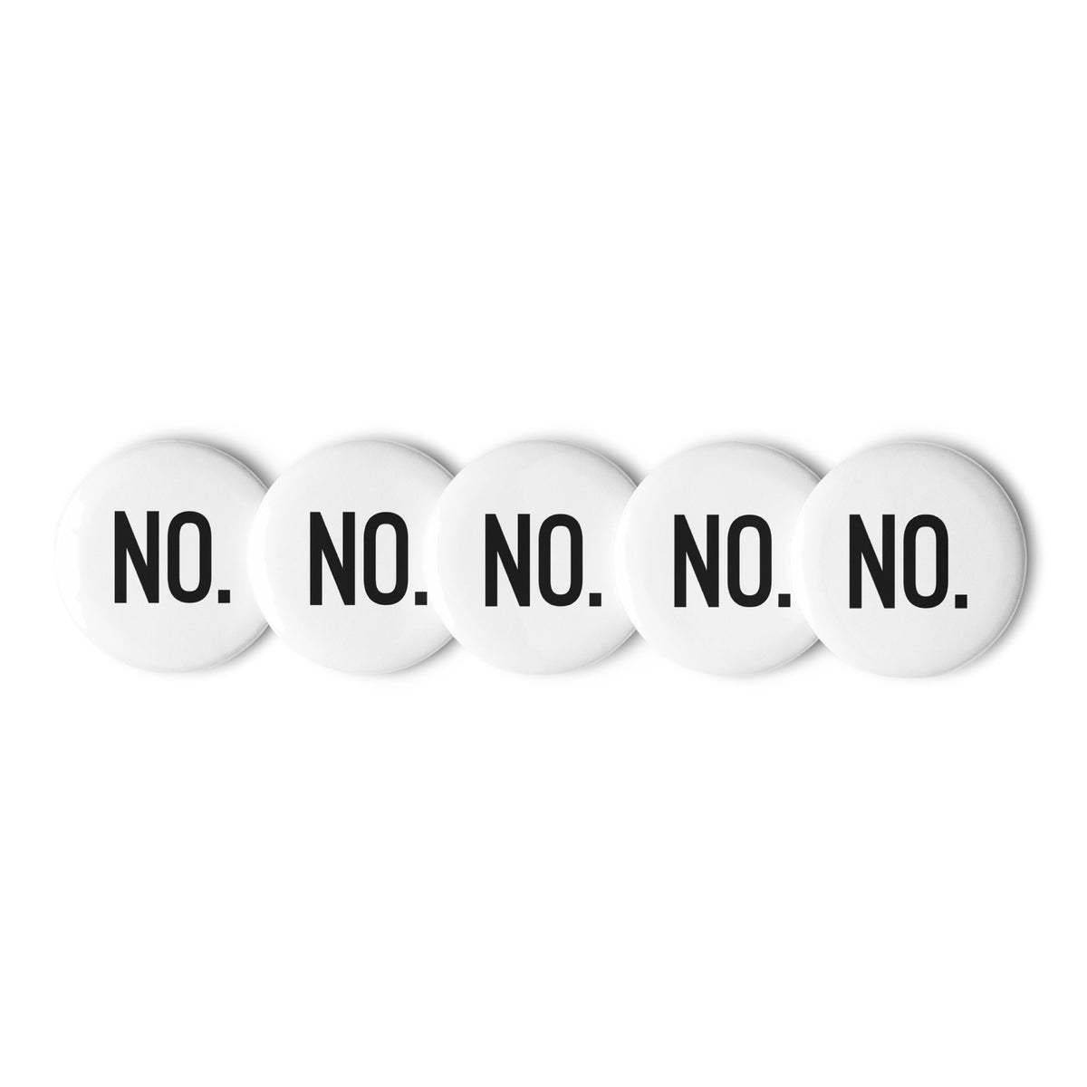 Front facing graphic pin buttons against a white background. Buttons are in color white and size 2.25 inches. Featuring the statement 'NO.' in bold black print. From What Was Said (Statement Apparel + More). 