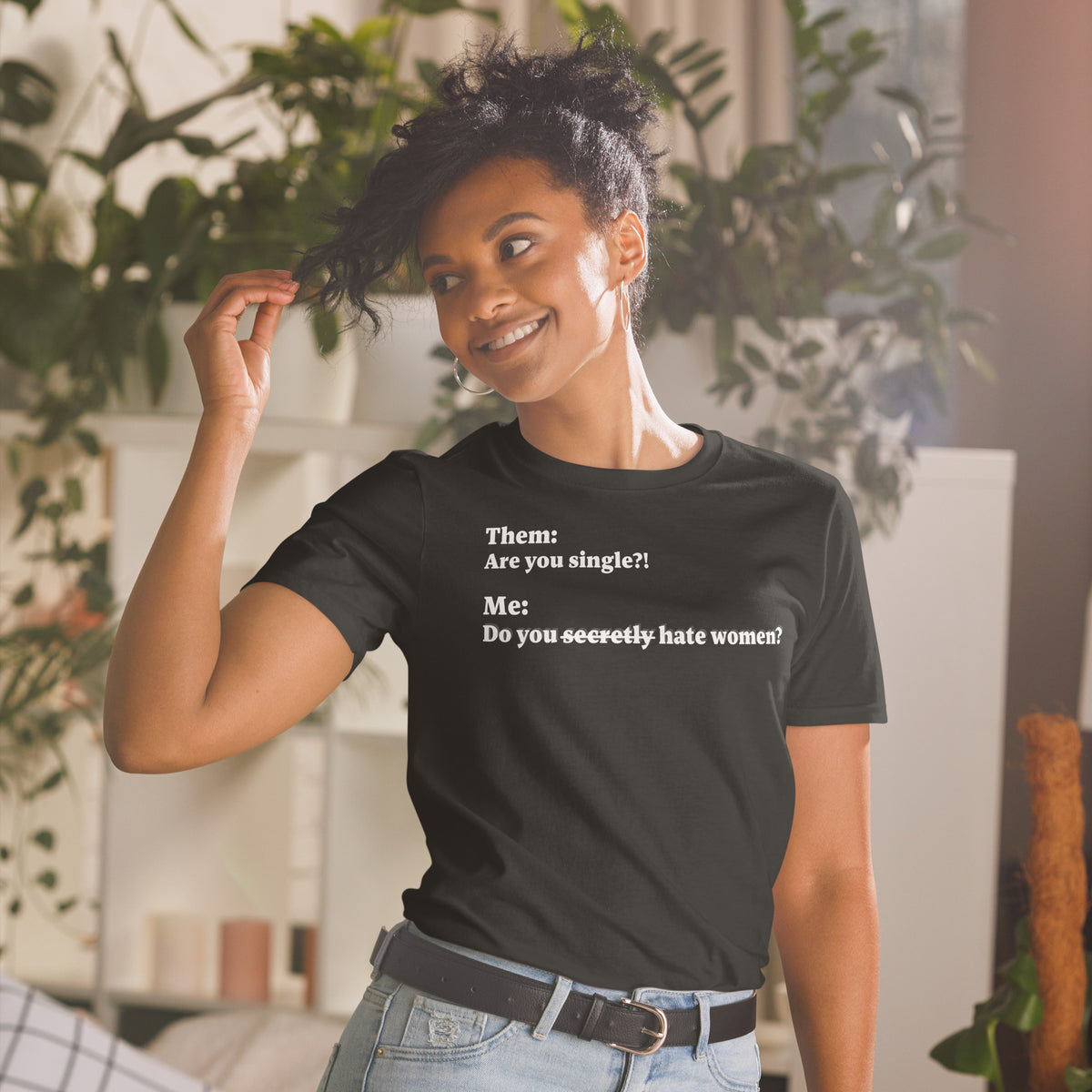 Model is wearing front facing graphic T-shirt in color black, featuring an asked question, 'Are you single?' and a response, 'Do you secretly hate women?' in white print, from What Was Said (Statement Apparel + More). 