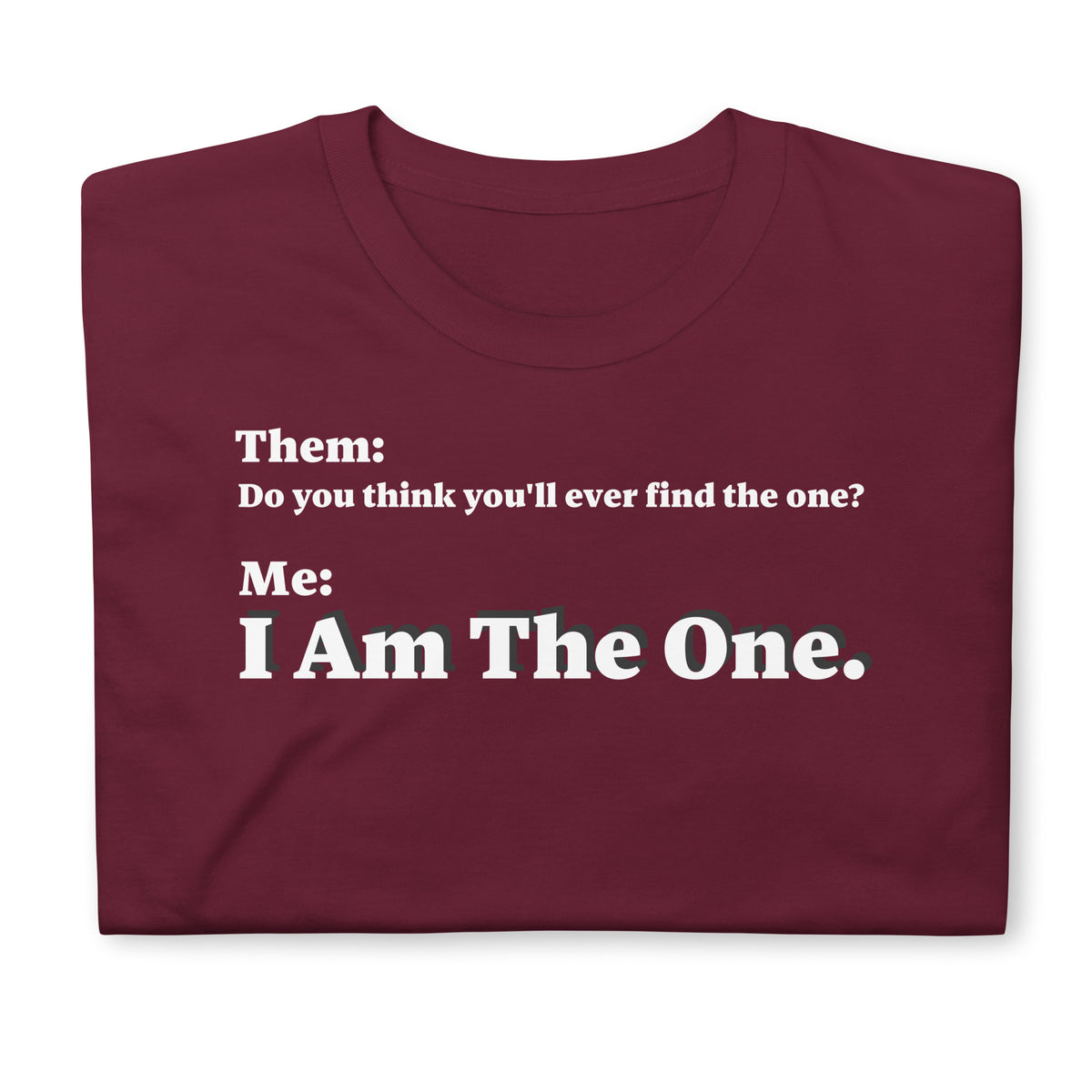 Folded front facing graphic T-shirt in color maroon red, featuring an asked question, 'Do you think you'll ever find the one?' and a response, 'I Am The One?' in bold white print, from What Was Said (Statement Apparel + More). 