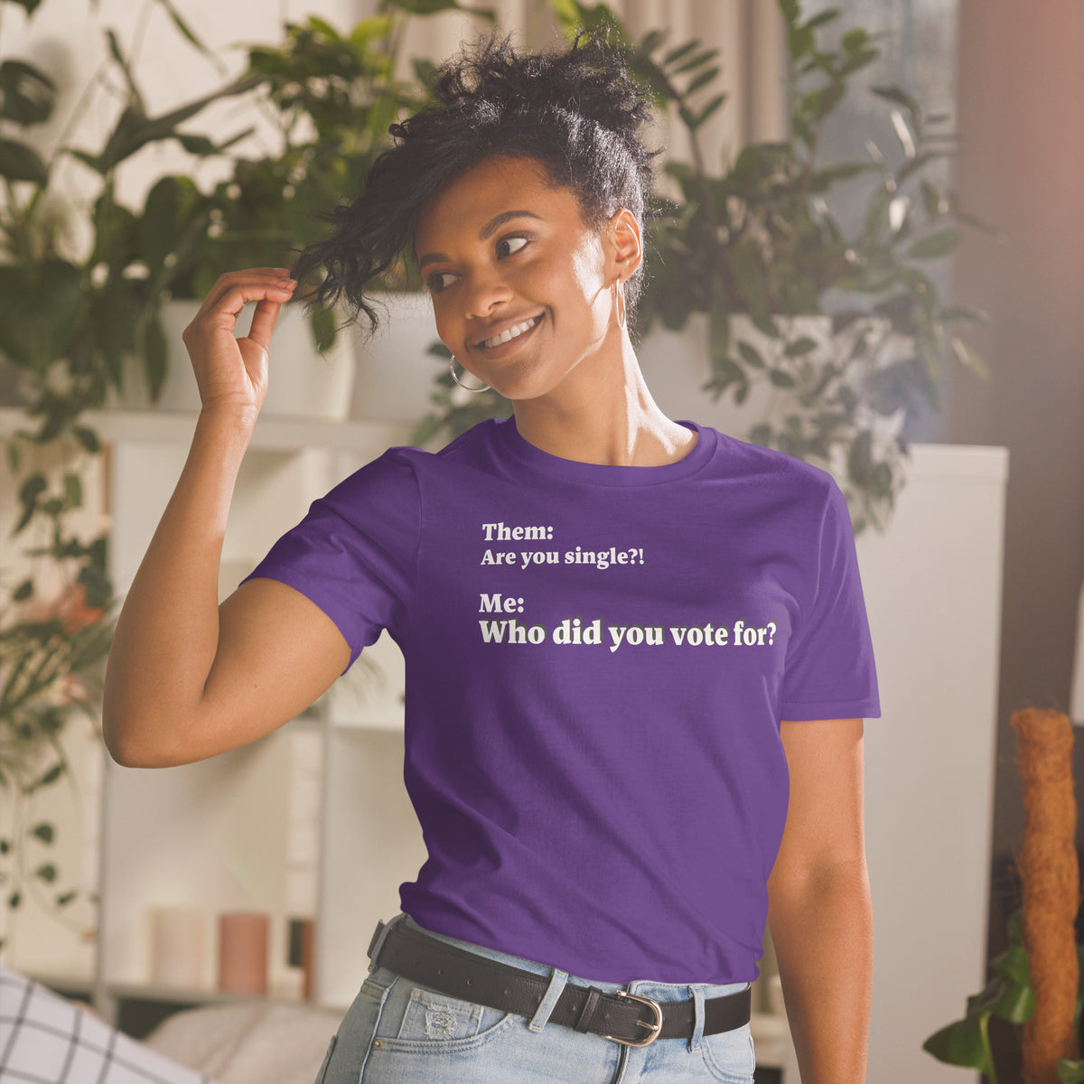 Model wearing front-facing graphic T-shirt in color purple, featuring an asked question, 'Are you single?' and a response, 'Who did you vote for?' in bold white print. From What Was Said (Statement Apparel + More). 