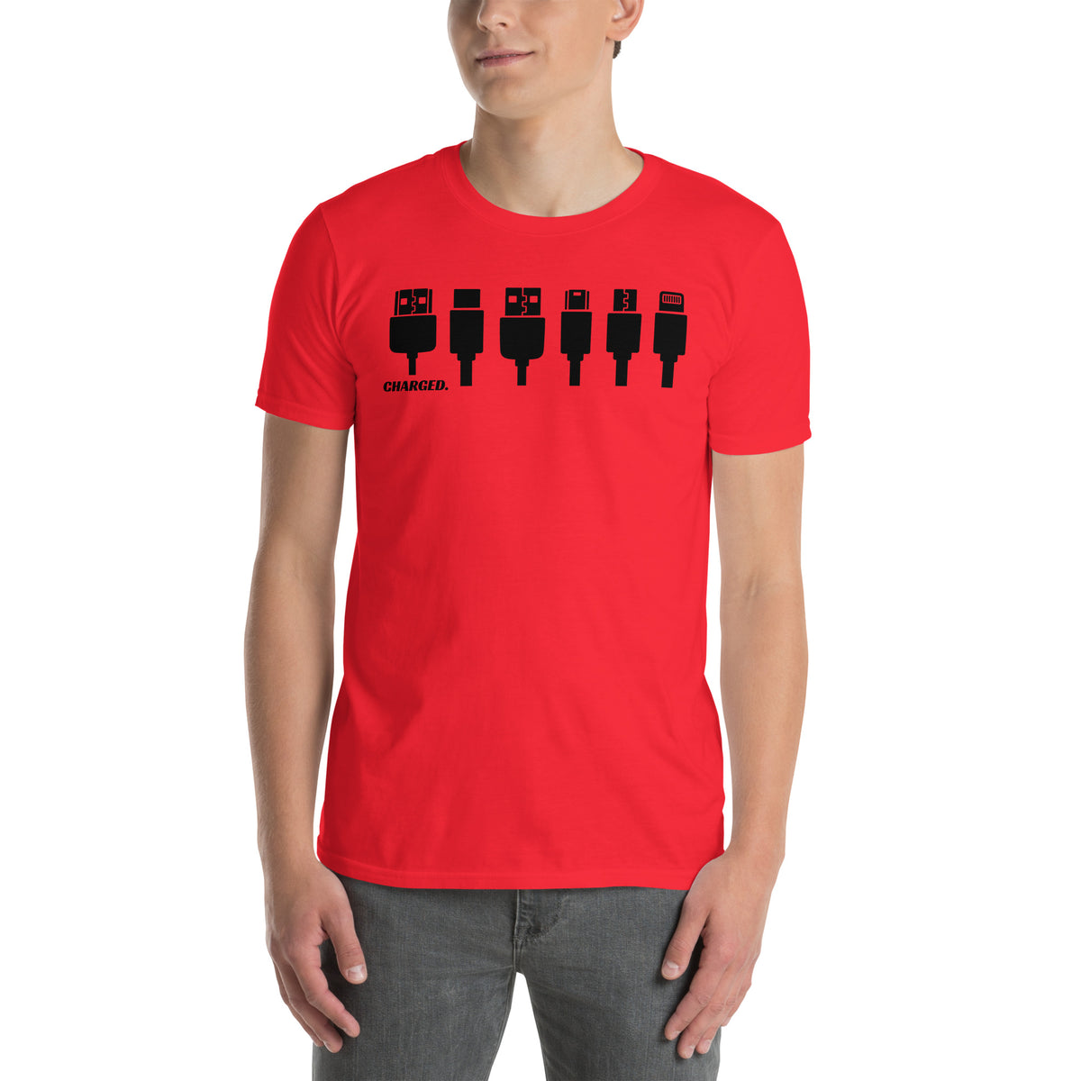 Model is wearing front facing graphic T-shirt in color red, featuring printed image of various device chargers and the written word 'CHARGED' in black print. From What Was Said (Statement Apparel + More).