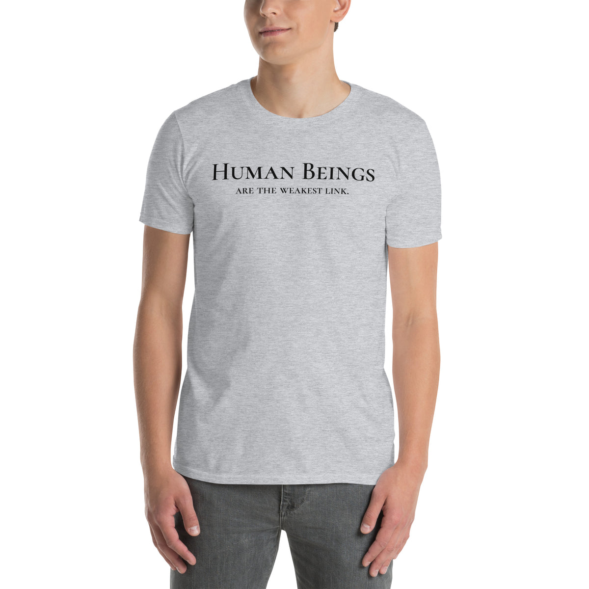 Model is wearing front facing graphic t-shirt in color sport grey, featuring statement 'HUMAN BEINGS ARE THE WEAKEST LINK', in black print. From What Was Said (Statement Apparel + More).