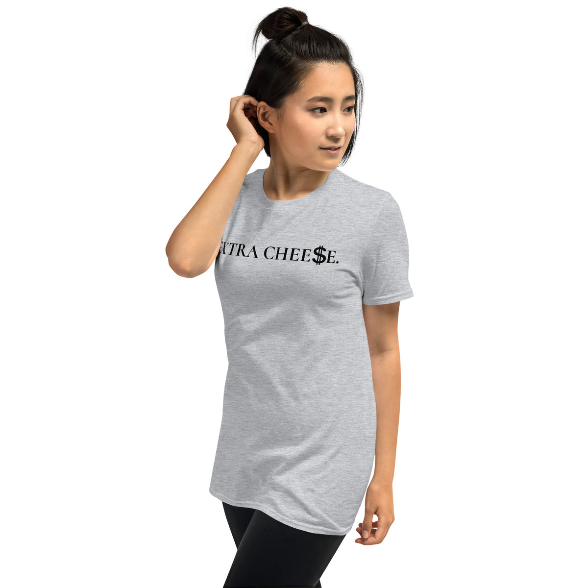 Model is wearing left front facing graphic T-shirt in color sport grey, featuring statement 'EXTRA CHEESE', with dollar sign symbol in place of the letter S in the word cheese, in black print. From What Was Said (Statement Apparel + More).