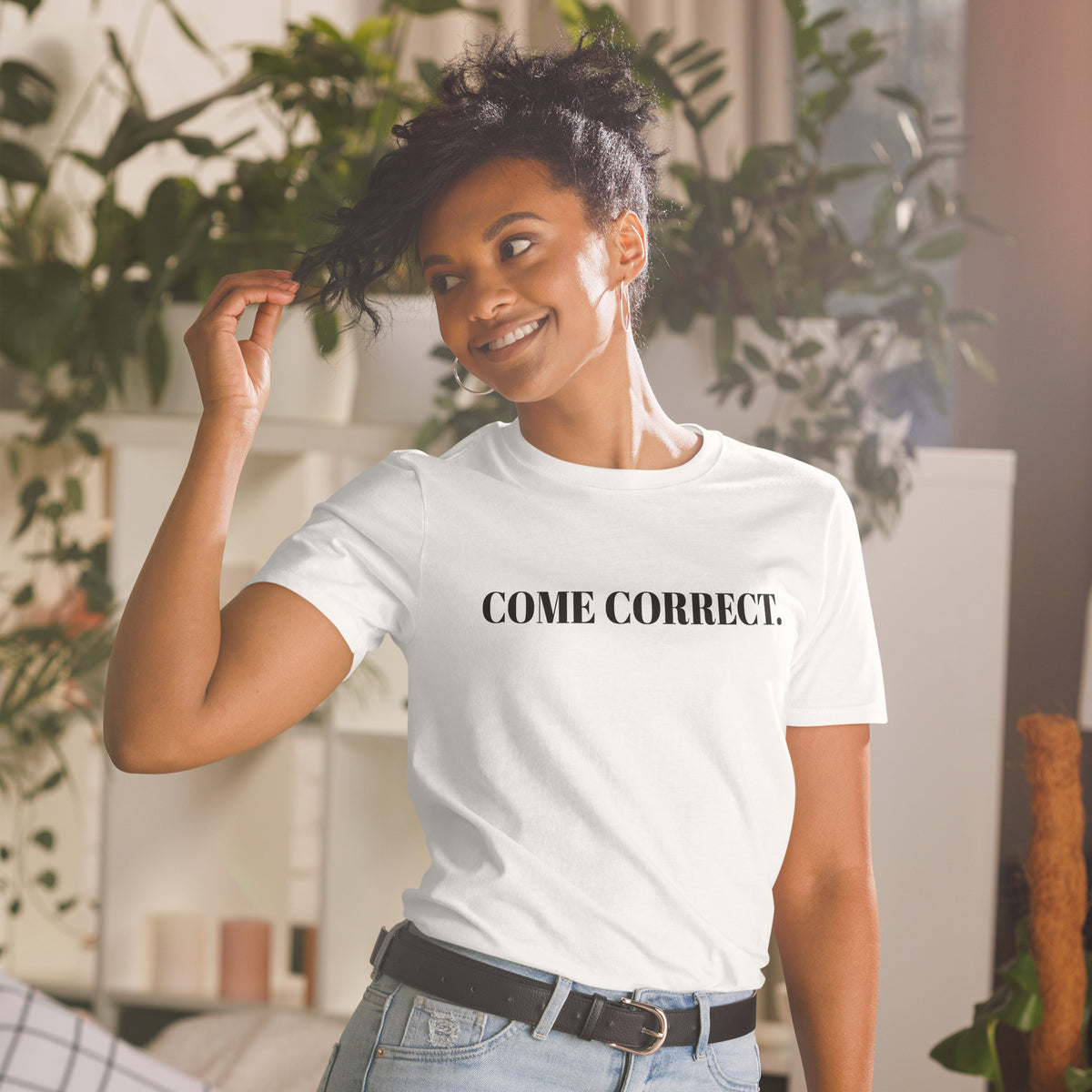 Model is wearing front facing graphic t-shirt in color white, featuring statement 'COME CORRECT', in bold black print. From What Was Said (Statement Apparel + More).