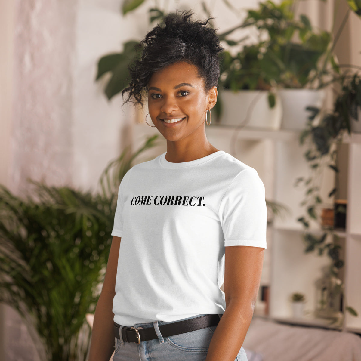 Model is wearing left front facing graphic t-shirt in color white, featuring statement 'COME CORRECT', in bold black print. From What Was Said (Statement Apparel + More).