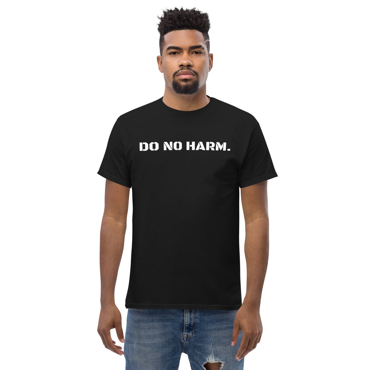 Model is wearing front facing graphic t-shirt in color black, featuring statement 'DO NO HARM', in bold white print. From What Was Said (Statement Apparel + More).