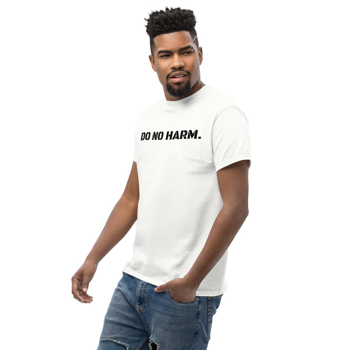 Model is wearing left front facing graphic t-shirt in color white, featuring statement 'DO NO HARM', in bold black print. From What Was Said (Statement Apparel + More).