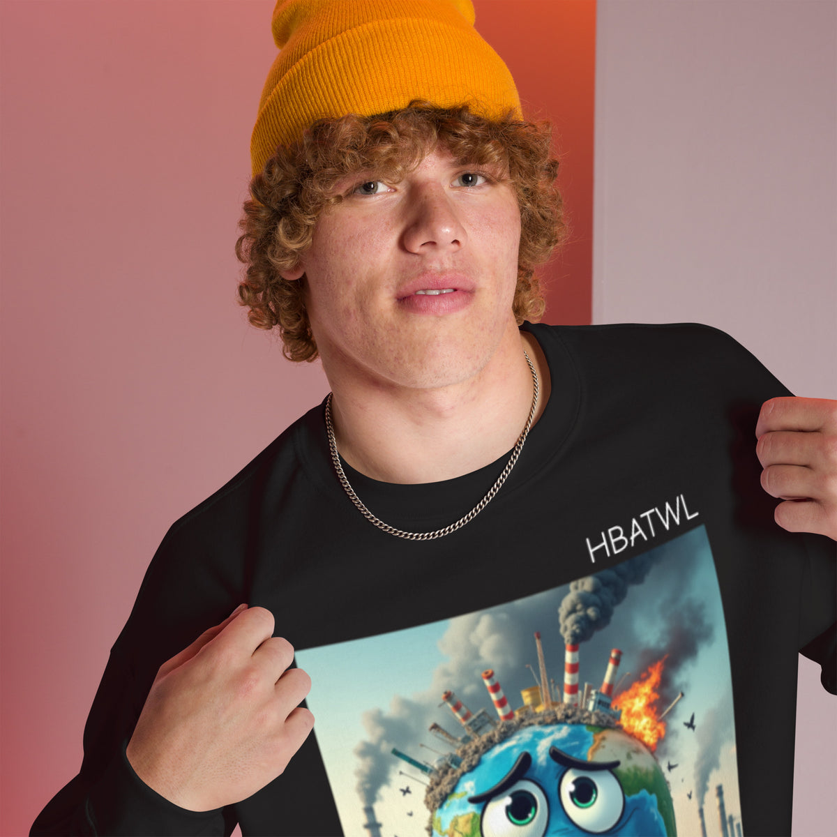 Model is wearing right front facing graphic sweatshirt in color black featuring an animated earth with facial expression of concern over being negatively effected by human pollution. Bold statement on the sweatshirt reads, 'Human Beings Are The Weakest link.', in white print. From What Was Said (Statement Apparel + More). mockup