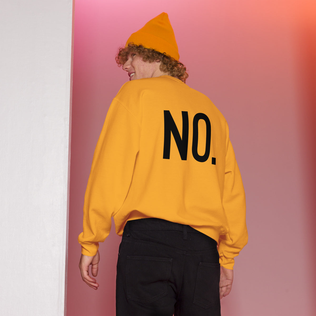 Model wearing back facing graphic sweatshirt in color gold yellow, featuring the statement 'NO.' in bold black print. from What Was Said (Statement Apparel + More). 