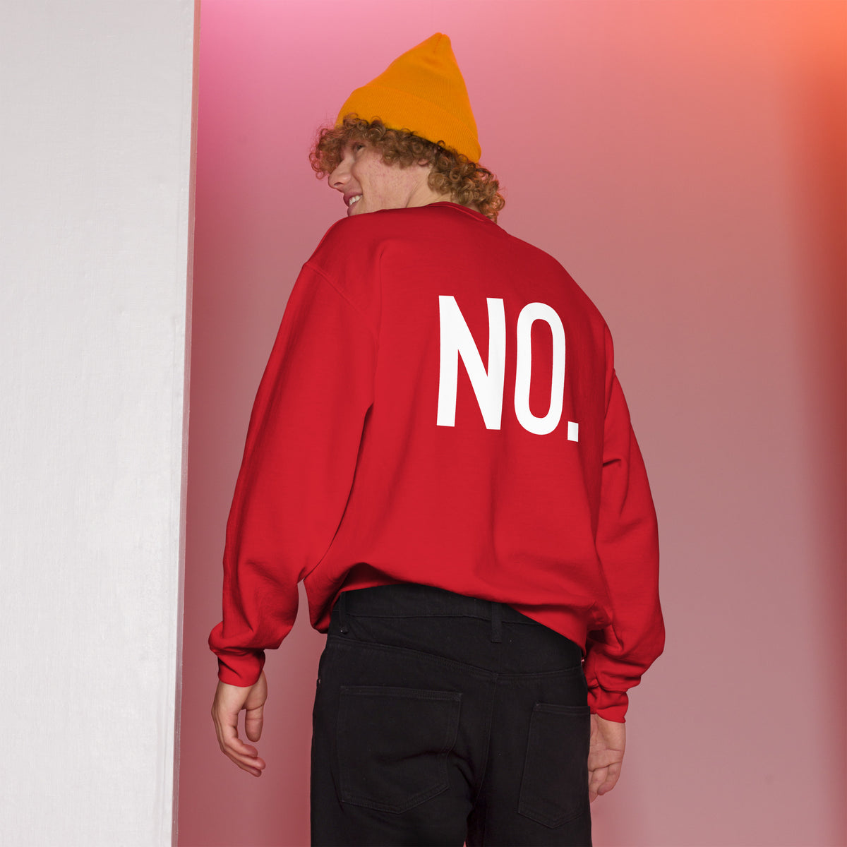 Model is wearing back facing graphic sweatshirt in color red, featuring the statement 'NO.' in bold white print, from What Was Said (Statement Apparel + More). 