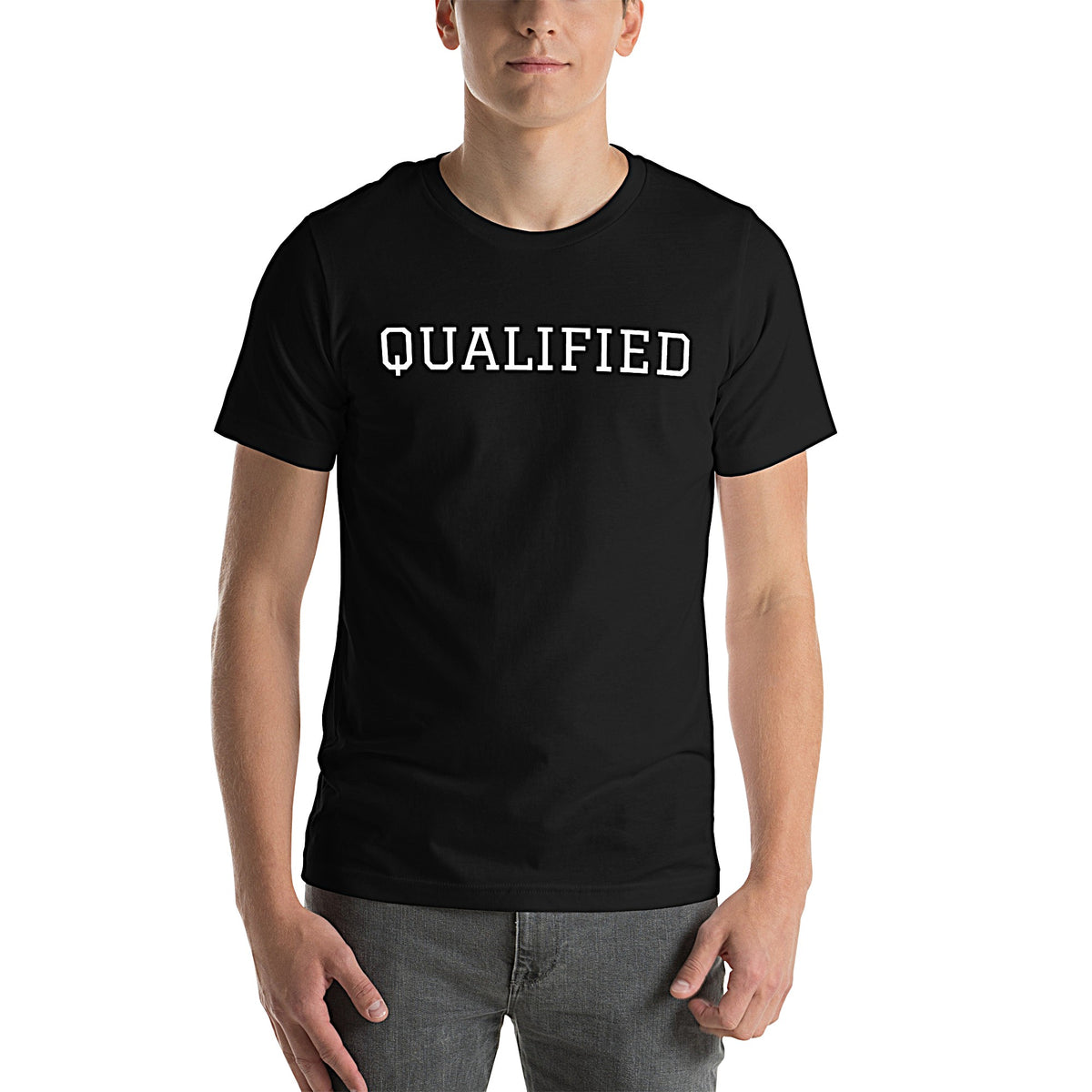Model wearing front-facing graphic T-shirt in color black featuring the word 'QUALIFIED' in bold white print, from What Was Said (Statement Apparel + More).