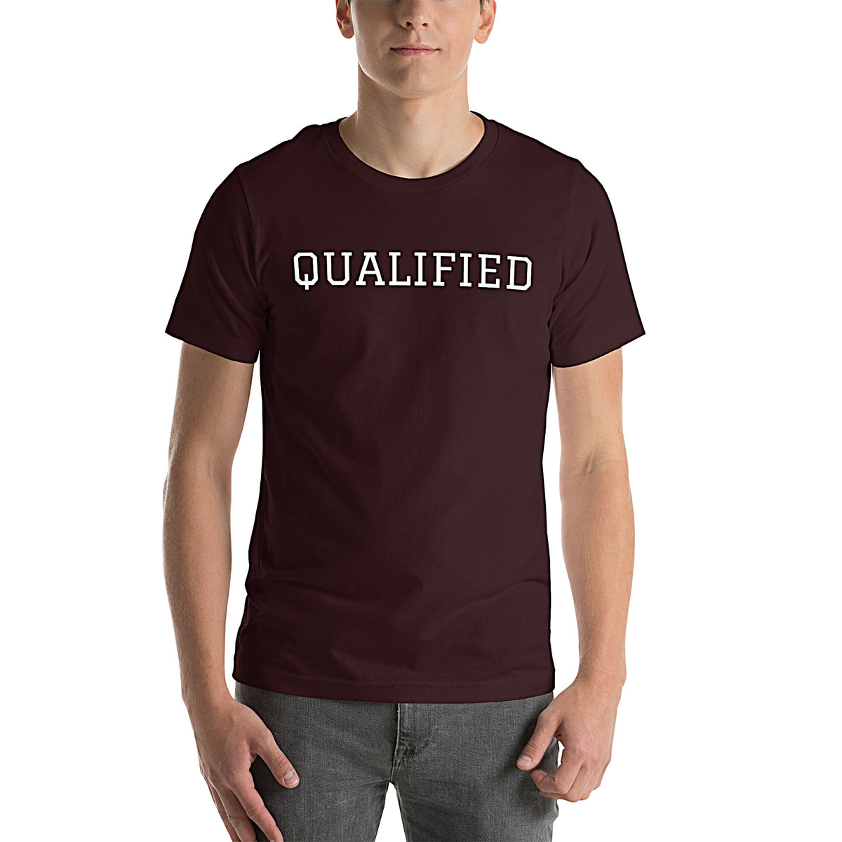 Model wearing front-facing graphic T-shirt in color oxblood dark reddish black, featuring the word 'QUALIFIED' in bold white print, from What Was Said (Statement Apparel + More).