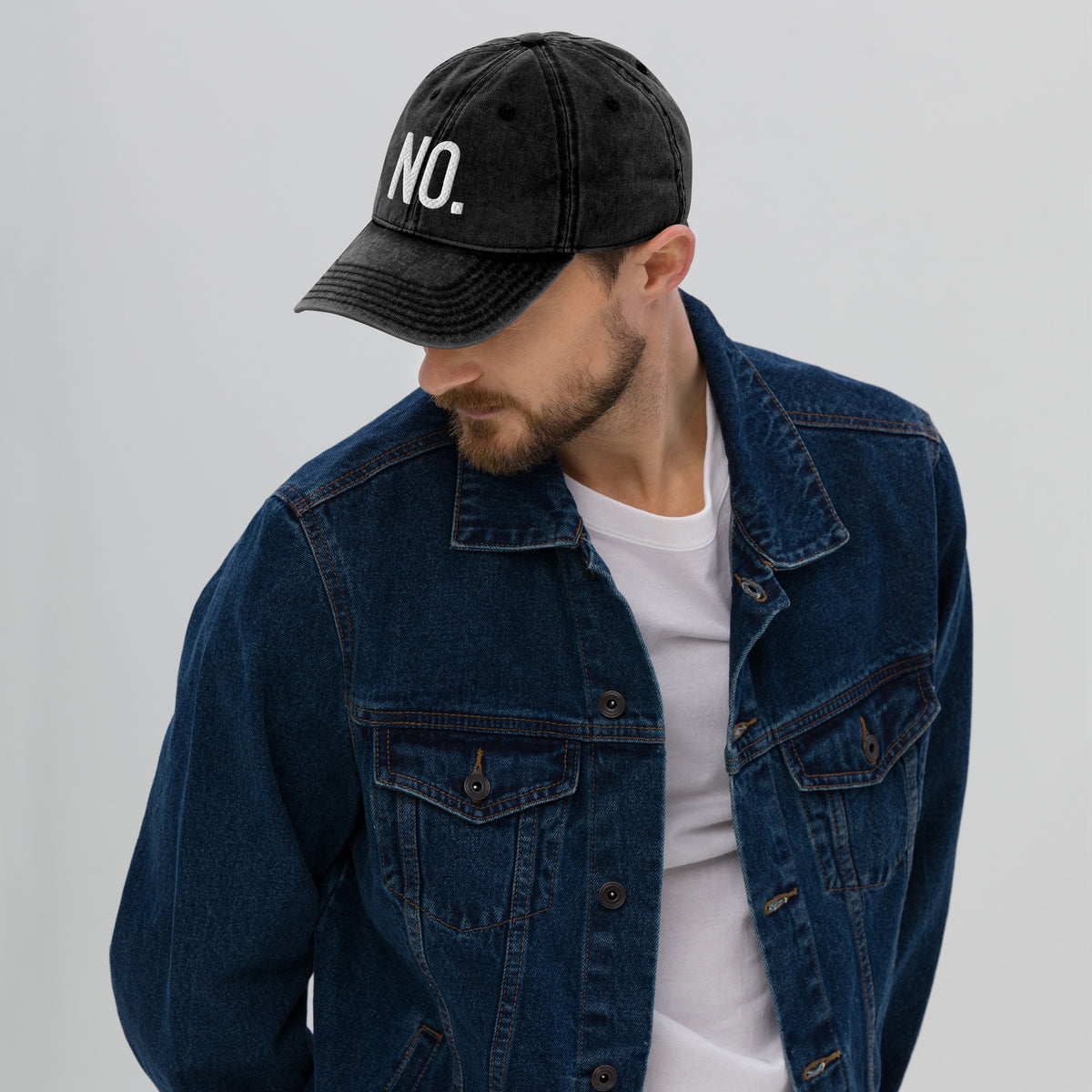 Model is wearing left front facing vintage graphic cotton twill cap in color black wash, featuring the statement 'NO.' in bold white embroidery. From What Was Said (Statement Apparel + More).