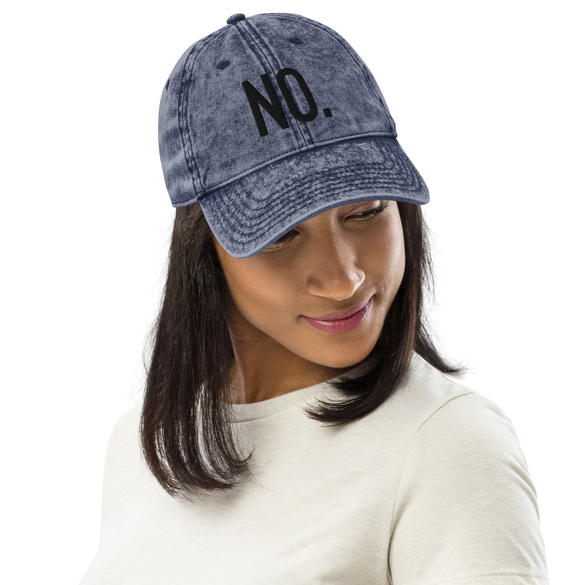Model is wearing front facing vintage graphic cotton twill cap in color navy blue wash, featuring the statement 'NO.' in bold black embroidery. From What Was Said (Statement Apparel + More).
