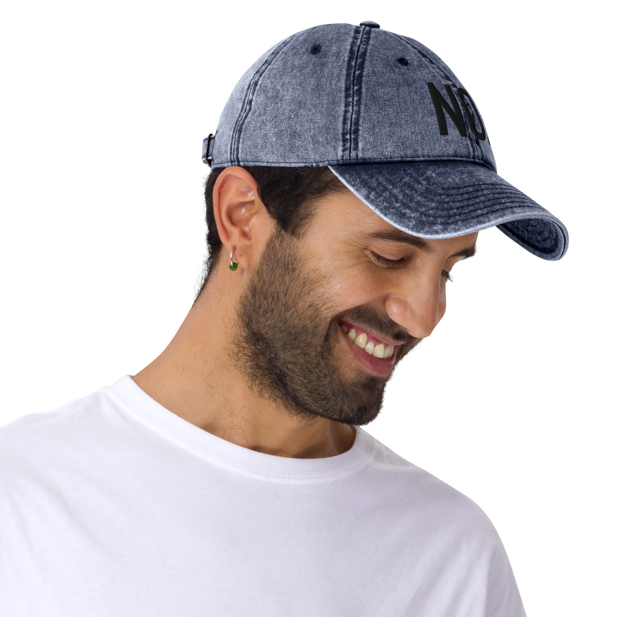 Model is wearing front facing vintage graphic cotton twill cap in color navy blue wash, featuring the statement 'NO.' in bold black embroidery. From What Was Said (Statement Apparel + More).