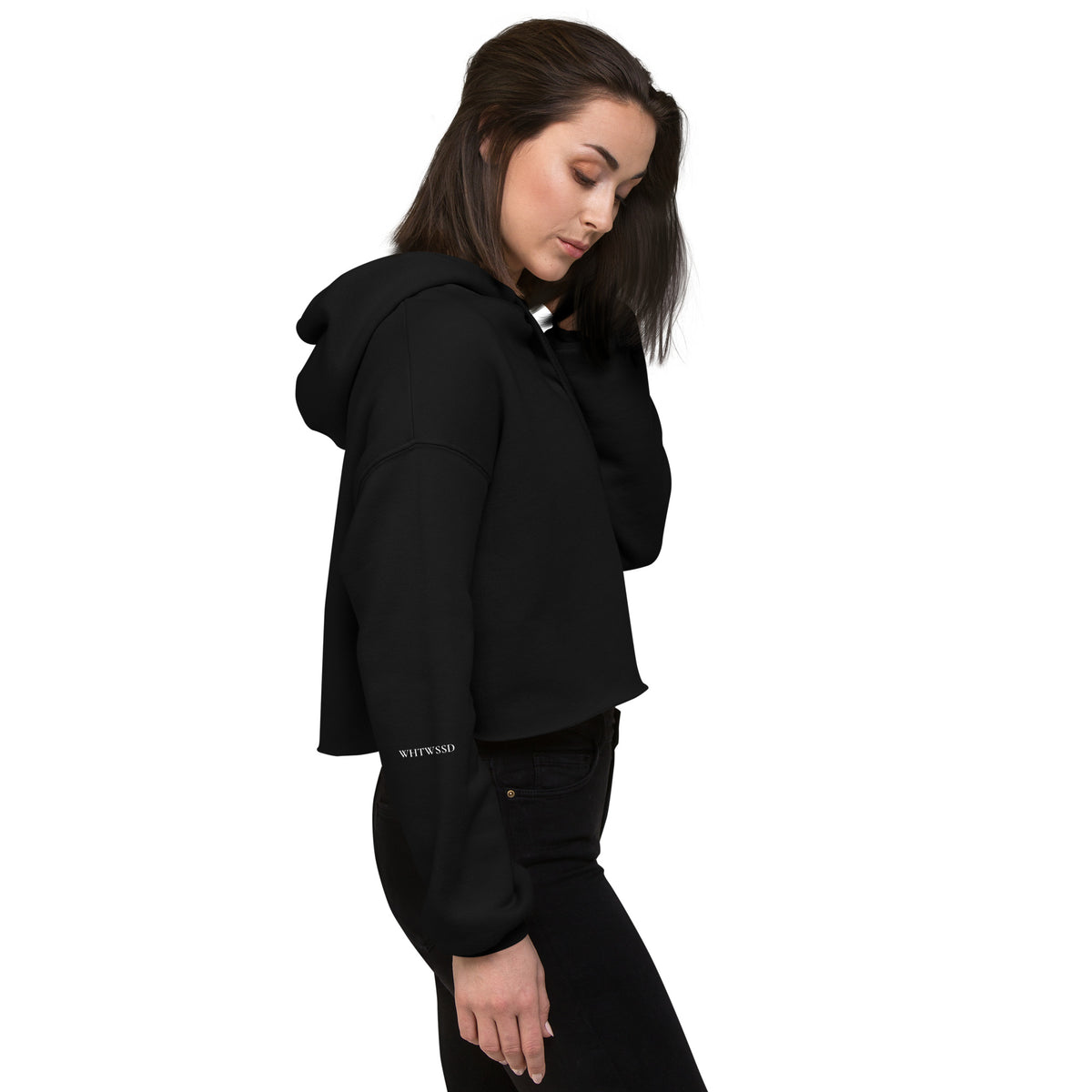 Model is wearing right side facing pullover graphic cropped hoodie in color black, featuring brand acronym, WHTWSSD in white print on sleave. From What Was Said (Statement Apparel + More). 