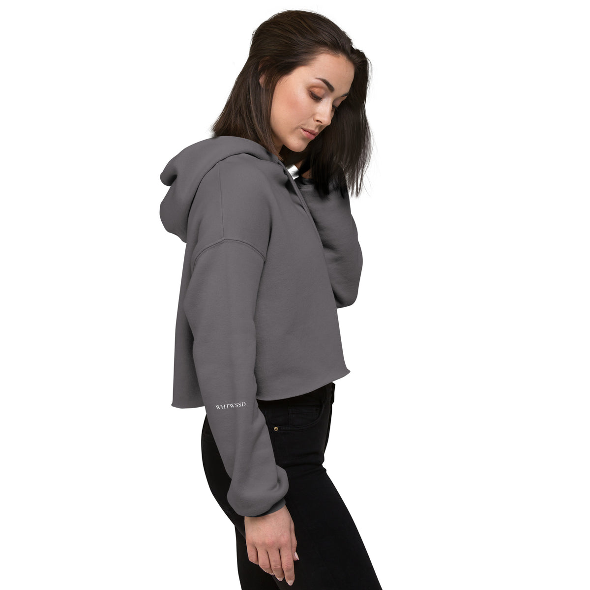 Model is wearing right side facing pullover graphic cropped hoodie in color storm grey, featuring brand acronym, WHTWSSD in white print on sleave. From What Was Said (Statement Apparel + More). 